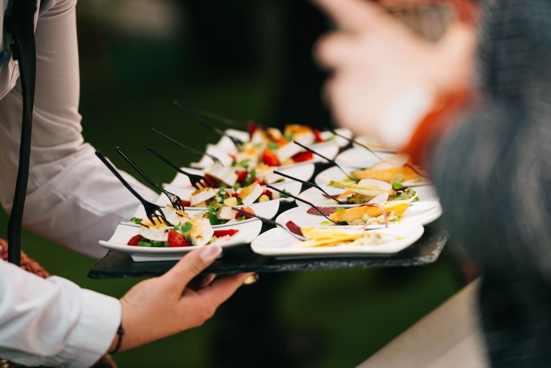 Charola con aperitivos gourmet en evento de catering